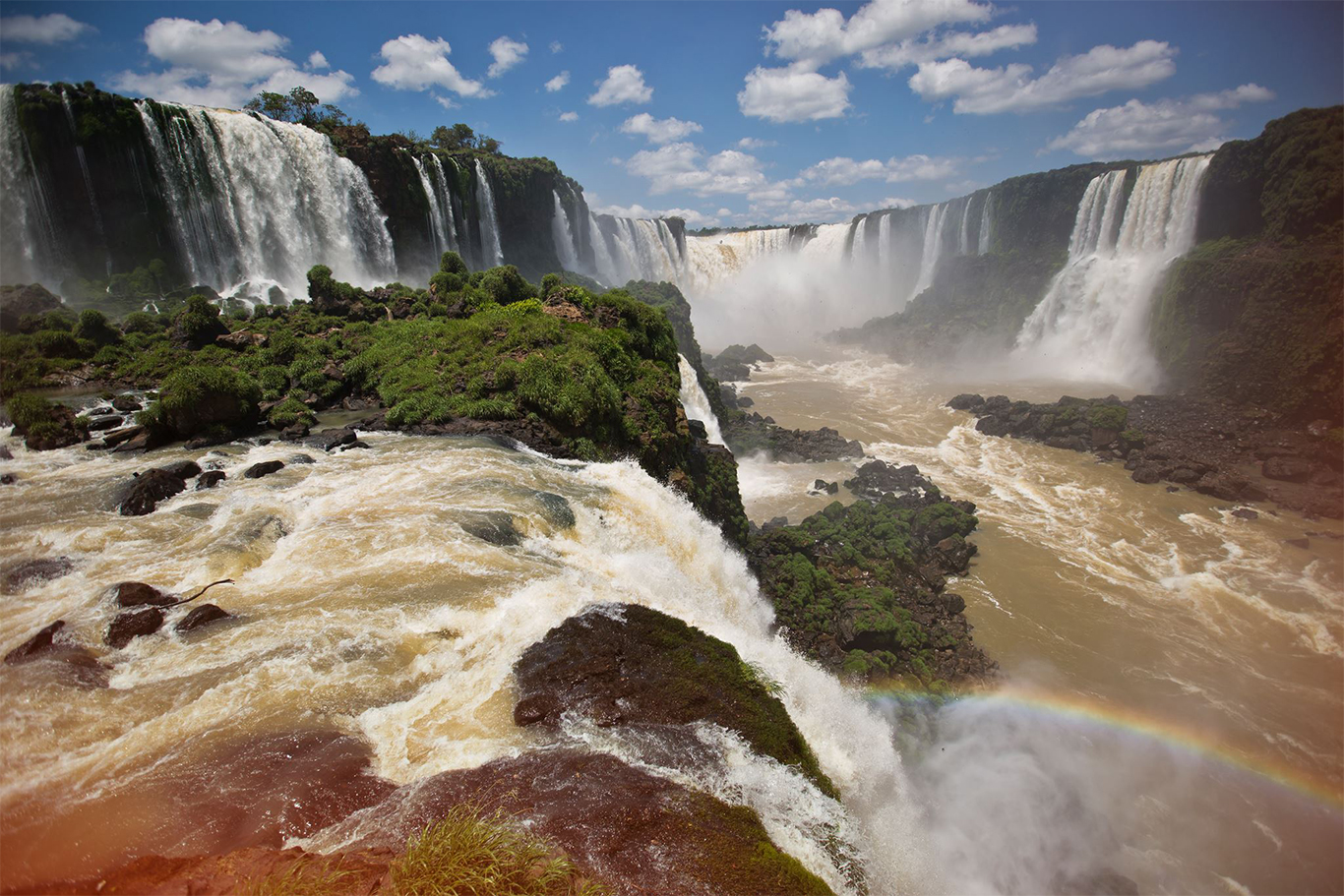 The roaring Iguassu Falls with added rainbow bordering Brazil and Argentina