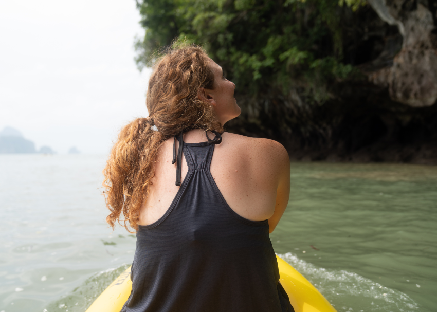A woman kayaking in the waters off Thailand